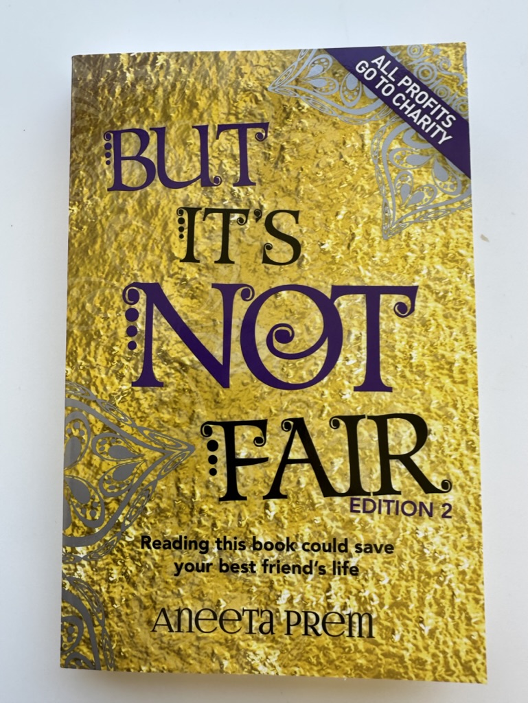 Gold second-edition cover of But It's Not Fair by Aneeta Prem