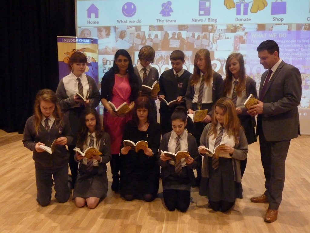 Pupils and adults reading the gold edition of But It's Not Fair together