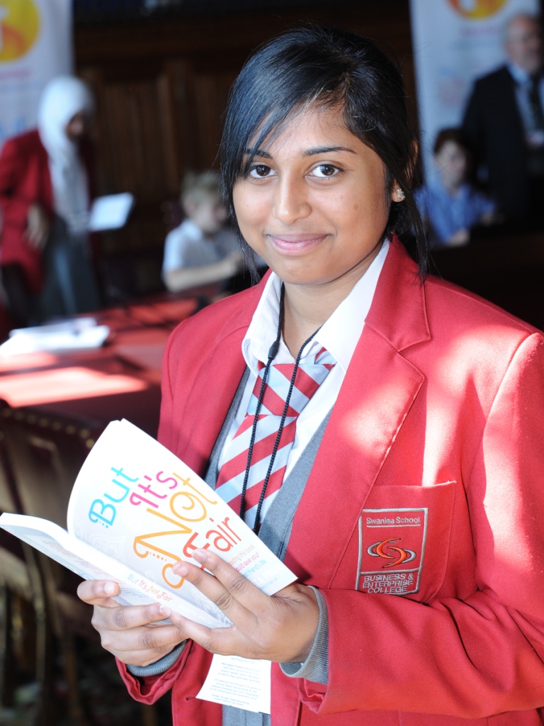 A secondary pupil reading the original edition of But It's Not Fair